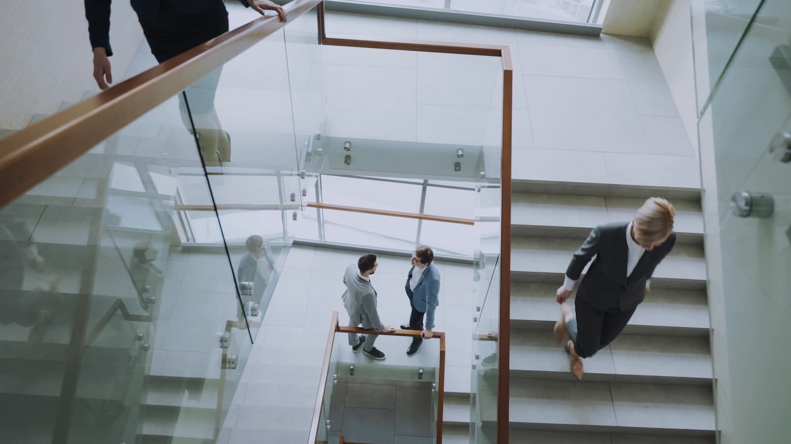 People moving through a modern building staircase